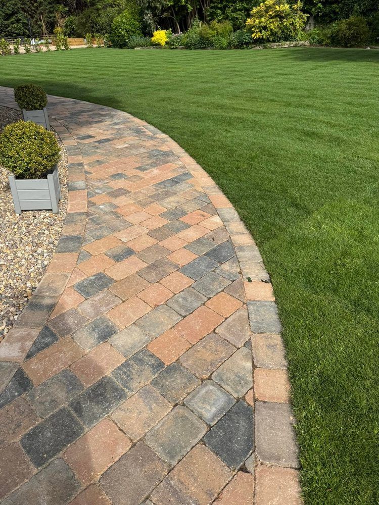 Block paved path with new turf