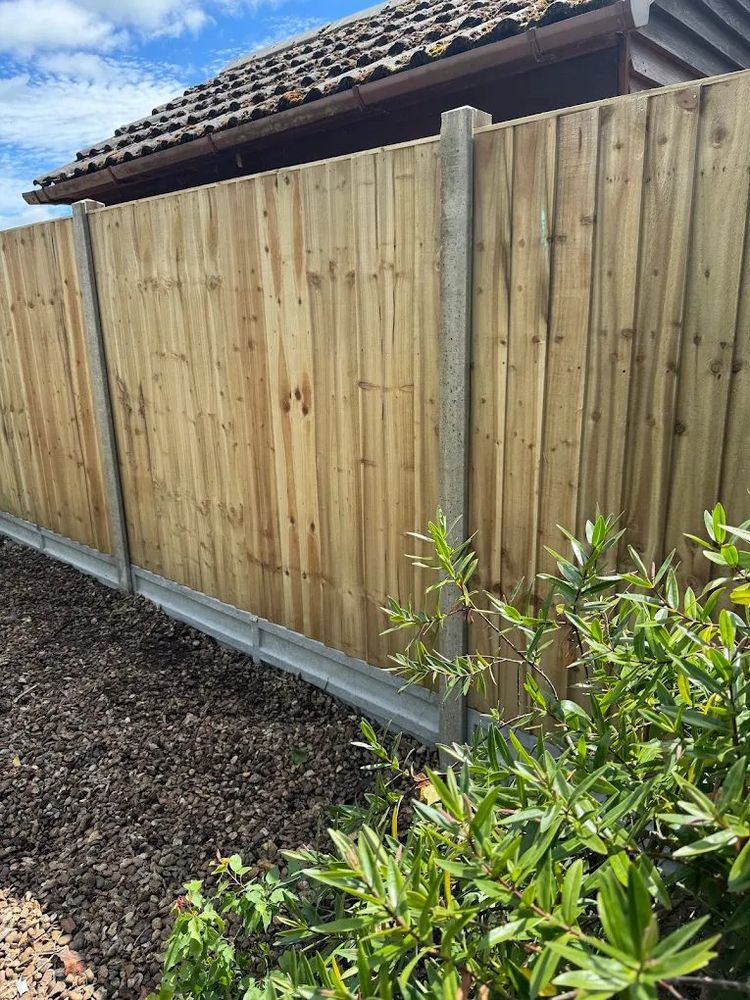 Close board fencing with concrete posts and gravel boards